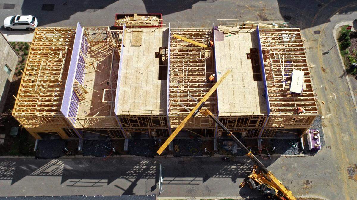 Construction workers work on another section of Pulte Homes along Siegle Avenue in Charlotte, NC on Thursday, July 8, 2021.