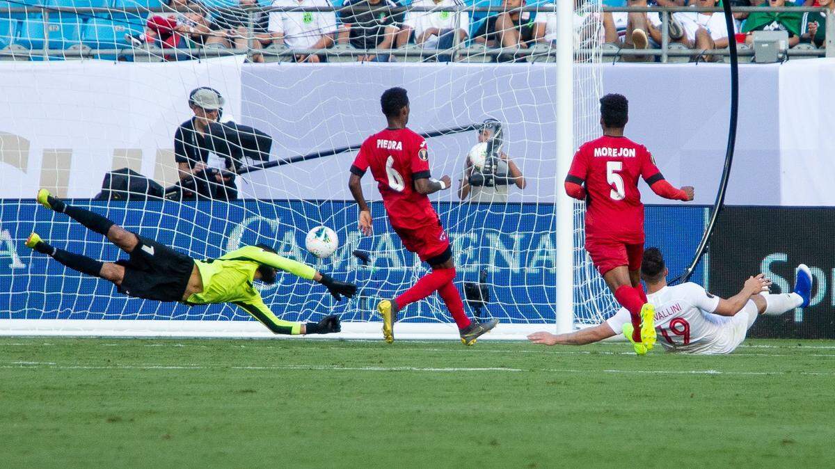 Canada’s Lucas Cavallini (19) slides after kicking the ball past Cuba goalkeeper Sandy Sanchez, left, during a Group A match in the 2019 Gold Cup at Bank of America Stadium in Charlotte on Sunday.