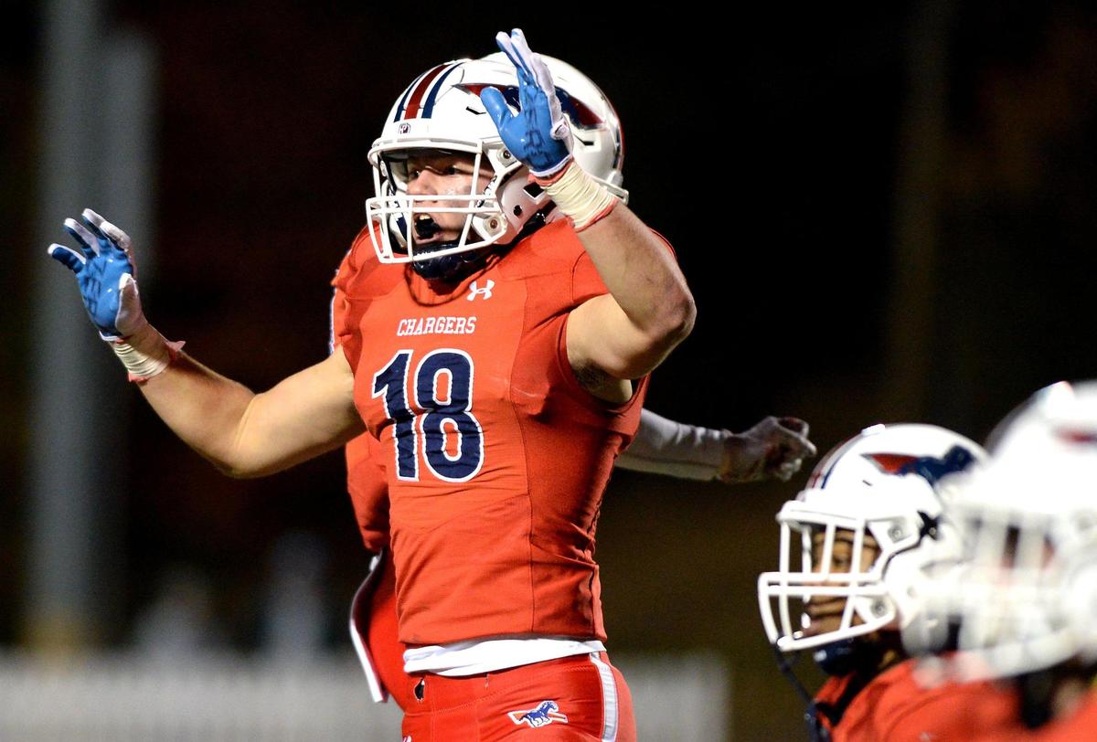 Providence Day Chargers defensive end Harrison Barnett, left, celebrates his recovery of a Rabun Gap fumble during first quarter action at Providence Day School in Charlotte, NC on Friday, November 19, 2021. The Chargers hosted Rabun Gap in the NCISAA boys state championship game.