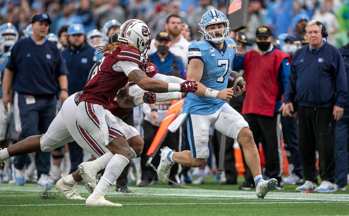 South Carolina’s R.J. Roderick (10) drives North Carolina quarterback Sam Howell (7) out of bounds in the second quarter during the Duke’s Mayo Bowl on Thursday, December 30, 2021 at Bank of America Stadium in Charlotte, N.C.