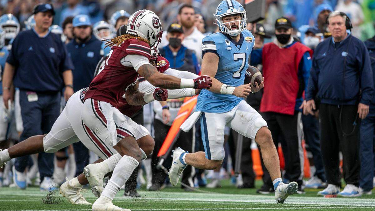 South Carolina’s R.J. Roderick (10) drives North Carolina quarterback Sam Howell (7) out of bounds in the second quarter during the Duke’s Mayo Bowl on Thursday, December 30, 2021 at Bank of America Stadium in Charlotte, N.C.