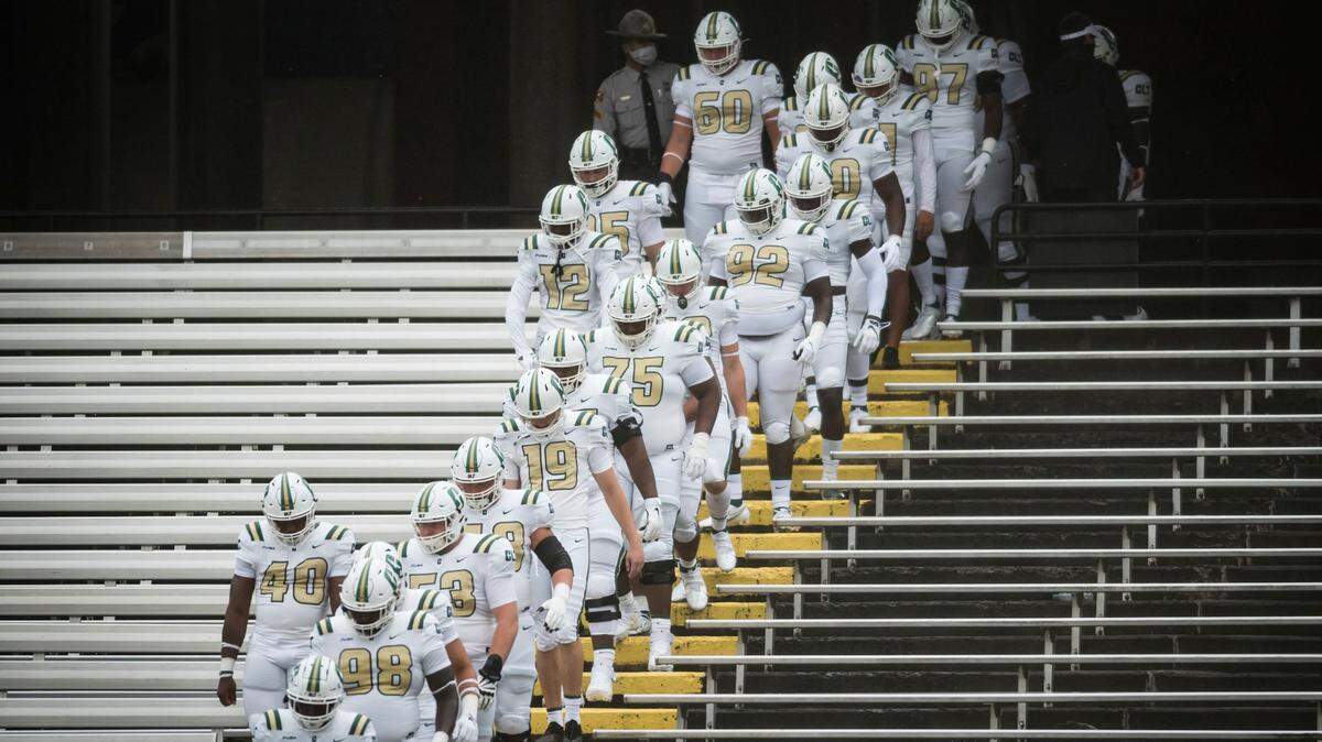 Charlotte players make their entrance to the field through empty bleachers for of their game at Appalachian State on Sept. 12. The 49ers have had their past two games canceled because of coronavirus concern.