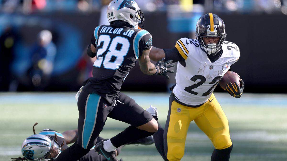Pittsburgh Steelers running back Najee Harris (22), right, stiff arms Carolina Panthers cornerback Keith Taylor Jr. (28) at the Bank of America Stadium in Charlotte, N.C., on Sunday, December 18, 2022.