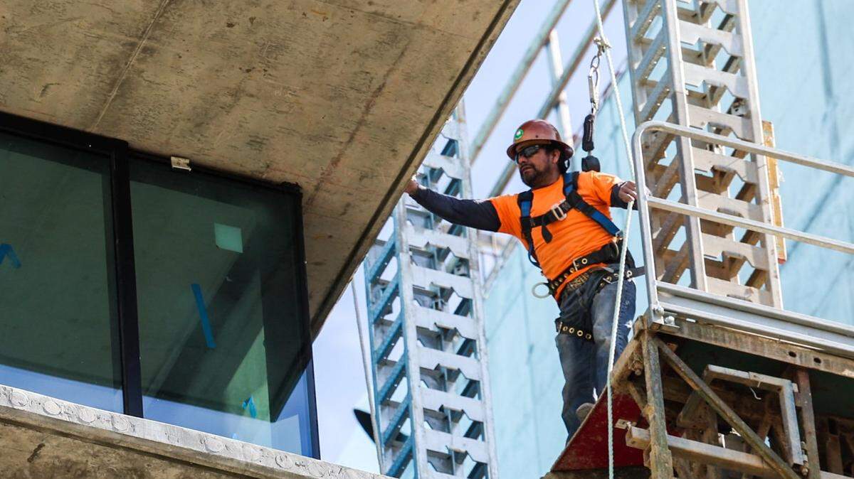 A worker working several floors above the ground at a construction site in Charlotte, NC on Wednesday, March 8, 2023