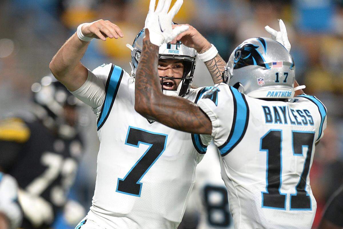 Carolina Panthers quarterback Will Grier, left, and wide receiver Omar Bayless celebrate Grier’s touchdown run against the Pittsburgh Steelers during a 2021 preseason game.