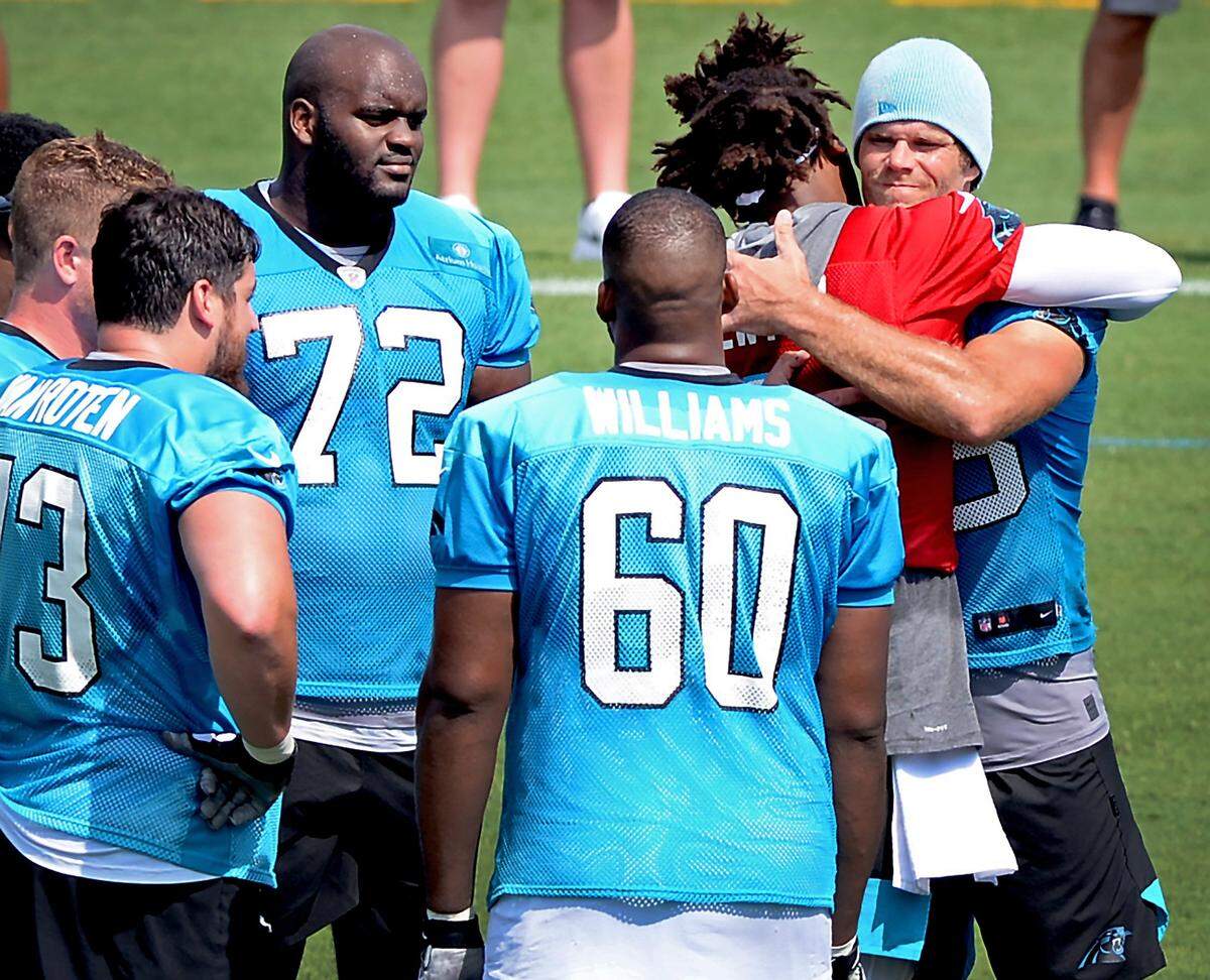 Carolina Panthers quarterback Cam Newton and tight end Greg Olsen hug during Day 2 of training camp in Spartanburg, S.C., on Friday. They arrived together in Charlotte in 2011 and combined for three straight 1,000-yard receiving seasons for Olsen from 2014-16.