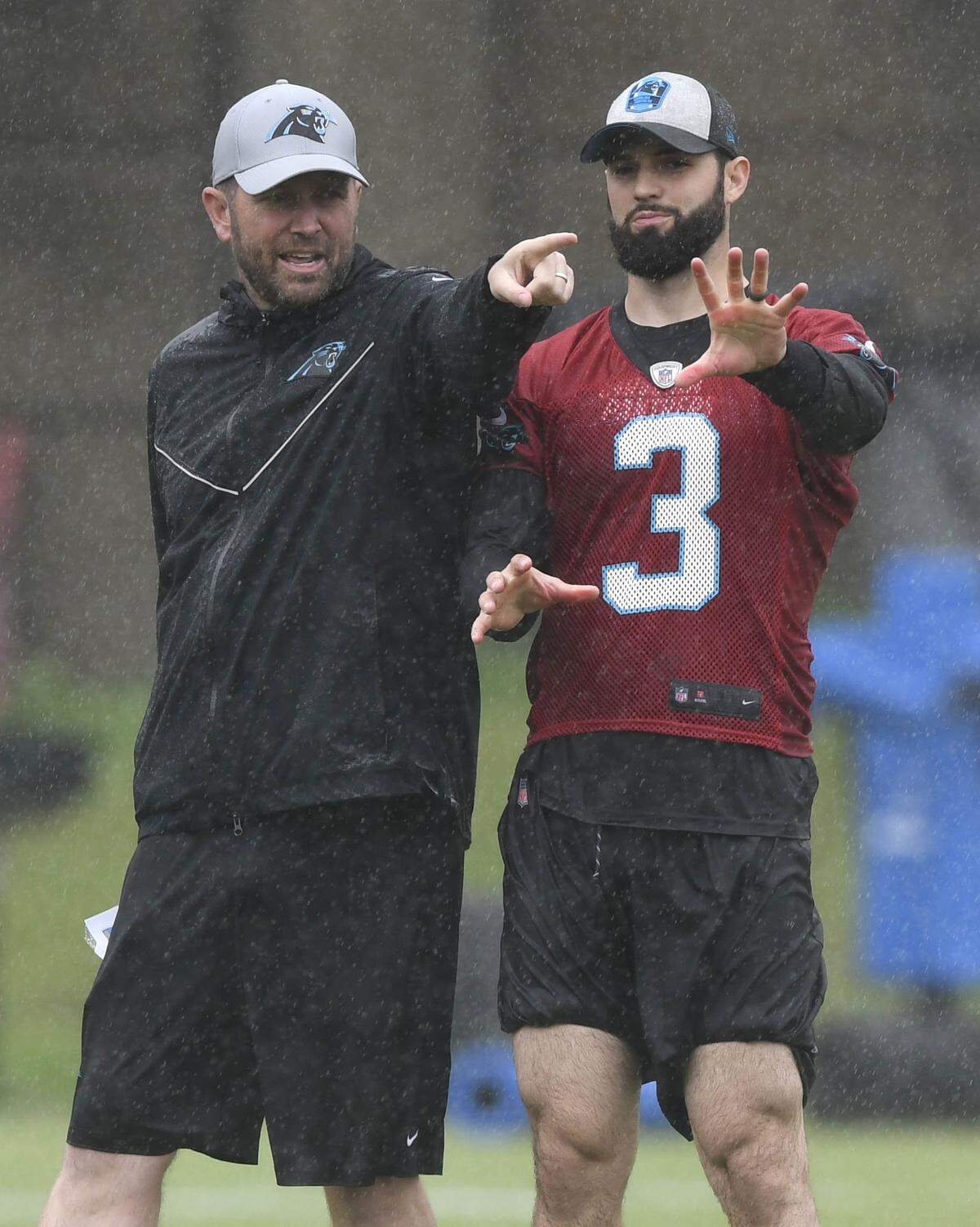 Carolina Panthers rookie Will Grier (3) gets instructions from quarterbacks coach Scott Turner during the team’s rookie minicamp Friday. Grier, 24, was the Panthers’ third-round draft pick in April and the fifth overall quarterback selected.