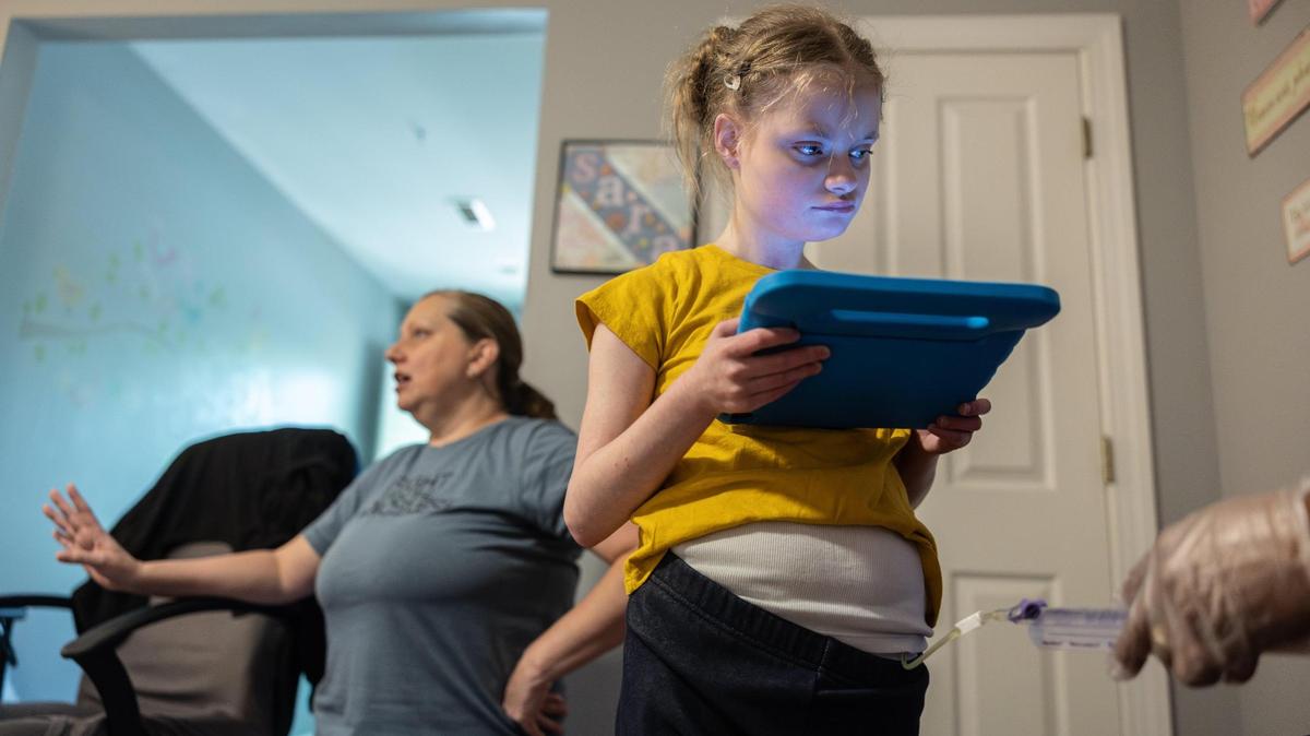 Emma Staggs’ nurse administers formula in her gastrostomy tube in Charlotte, N.C., on Tuesday, April 11, 2025.