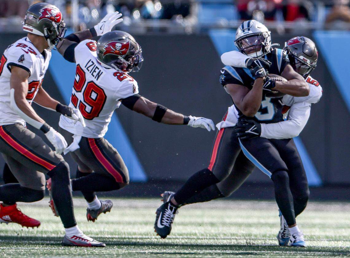 Carolina Panthers running back Raheem Blackshear, front, is tackled by Tampa Bay Buccaneers punter Jake Camarda at the Bank of America Stadium in Charlotte, N.C., on Sunday, January 7, 2024.