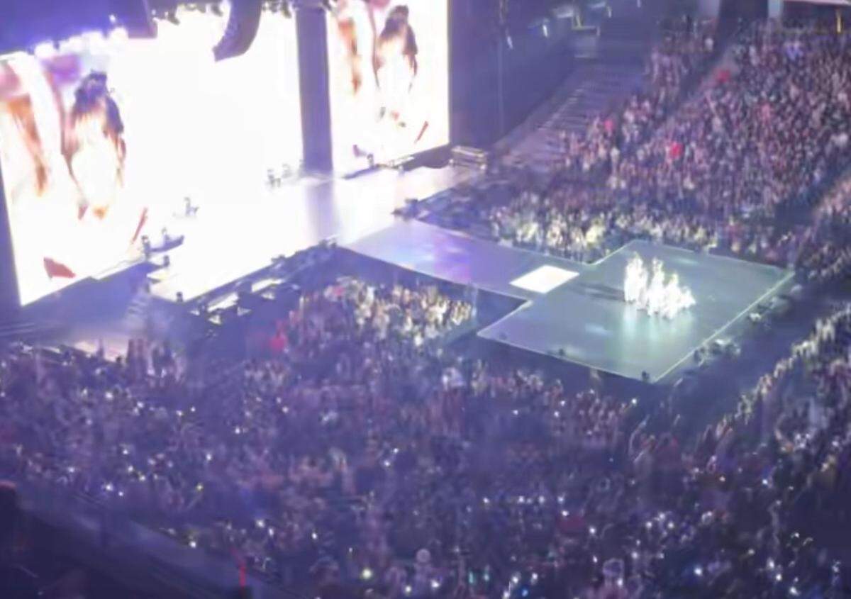The view from section 208 of the aespa concert at Charlotte’s Spectrum Center The orbs of light are lightsticks, which are battery-operated handheld lights that can pair with the concert’s electronics and change color with the songs.