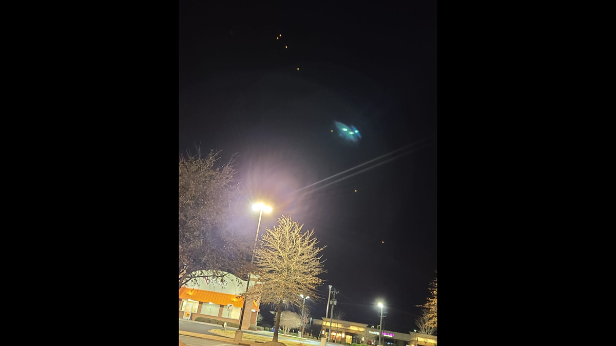 A string of lights seen floating in the night sky east of Charlotte has ignited debate on social media, including talk of UFOs and test rockets.