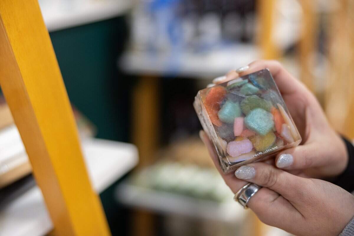 Jennifer Swenk, owner of Sparta Candle Co., holds up one of the soaps.