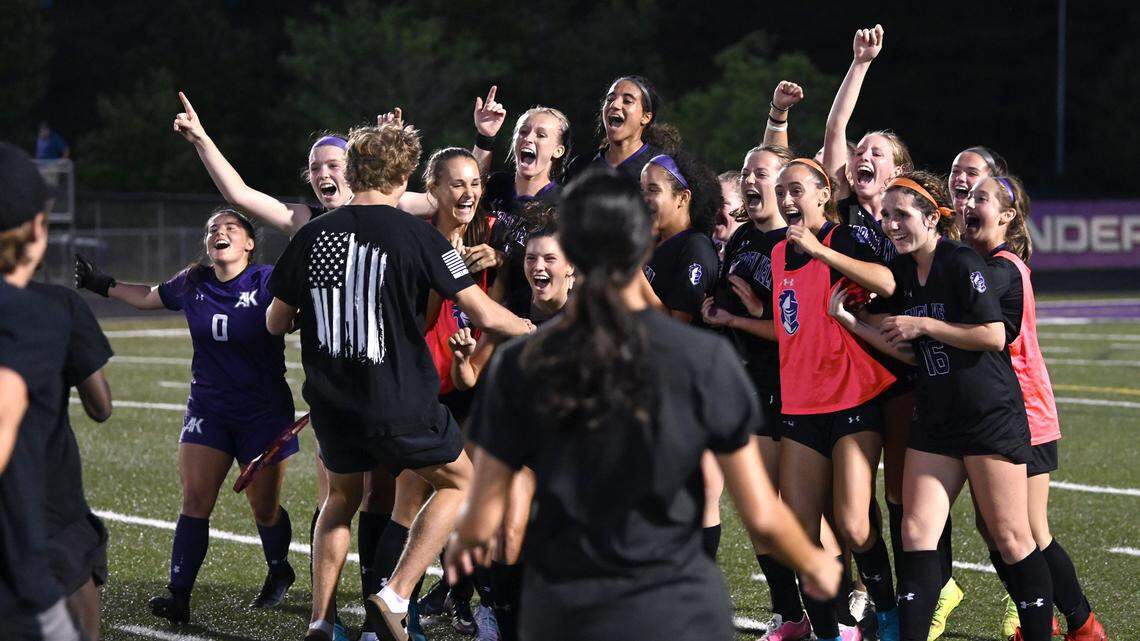 The Ardrey Kell girls soccer team turn to celebrate their 2-1 victory over Hough with their fans as they rush onto the field on Thursday, May 26, 2022. The teams were competing in a state quarterfinals girls soccer match.