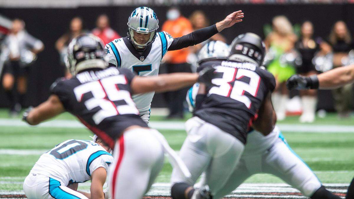 Panthers kicker Zane Gonzalez, back center, kicks a fifty-seven yard field goal to bring the Panthers within one point of the Falcons before the half during the game at Mercedes-Benz Stadium on Sunday, October 31, 2021 in Atlanta, GA.
