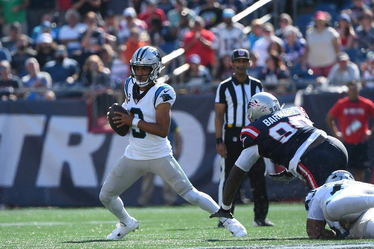 Carolina Panthers quarterback Bryce Young (9) eludes the tackle of New England Patriots defensive tackle Christian Barmore (90) during Sunday’s first half at Gillette Stadium.