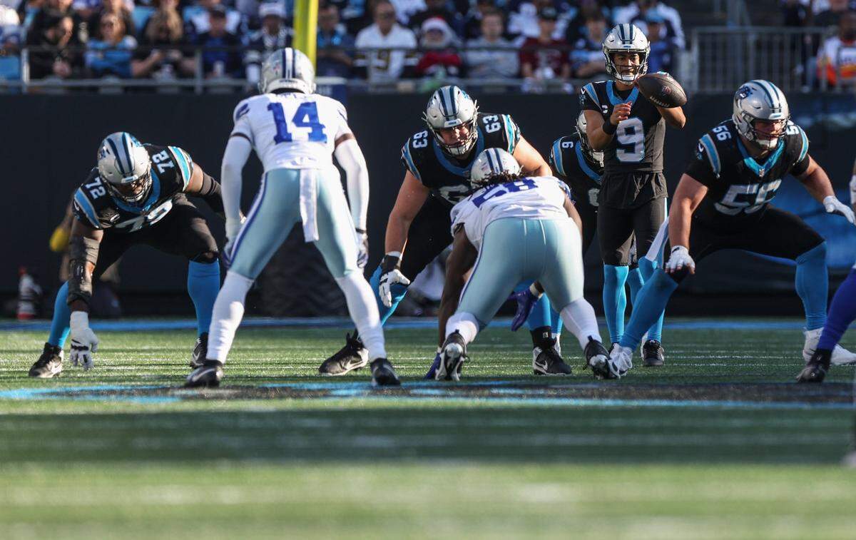 Panthers offensive linemen hold the line after the ball is snapped during the game against the Cowboys at Bank of America Stadium on Sunday, November 19, 2023 in Charlote, NC.