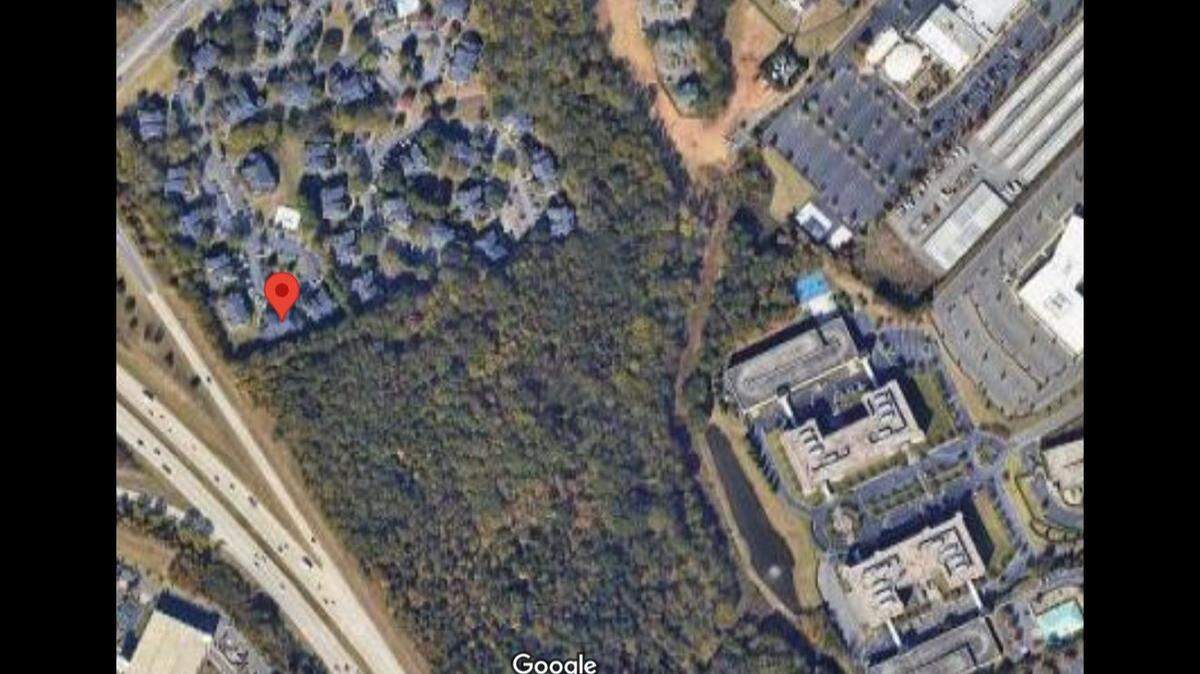 A death investigation is underway in southwest Charlotte after a body was found in the woods near an apartment complex.