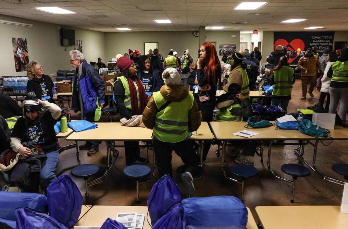 Volunteers fill a room of the Mecklenburg County Public Services building in uptown as they prepare to head out in their respective groups for the annual survey of the homeless population.