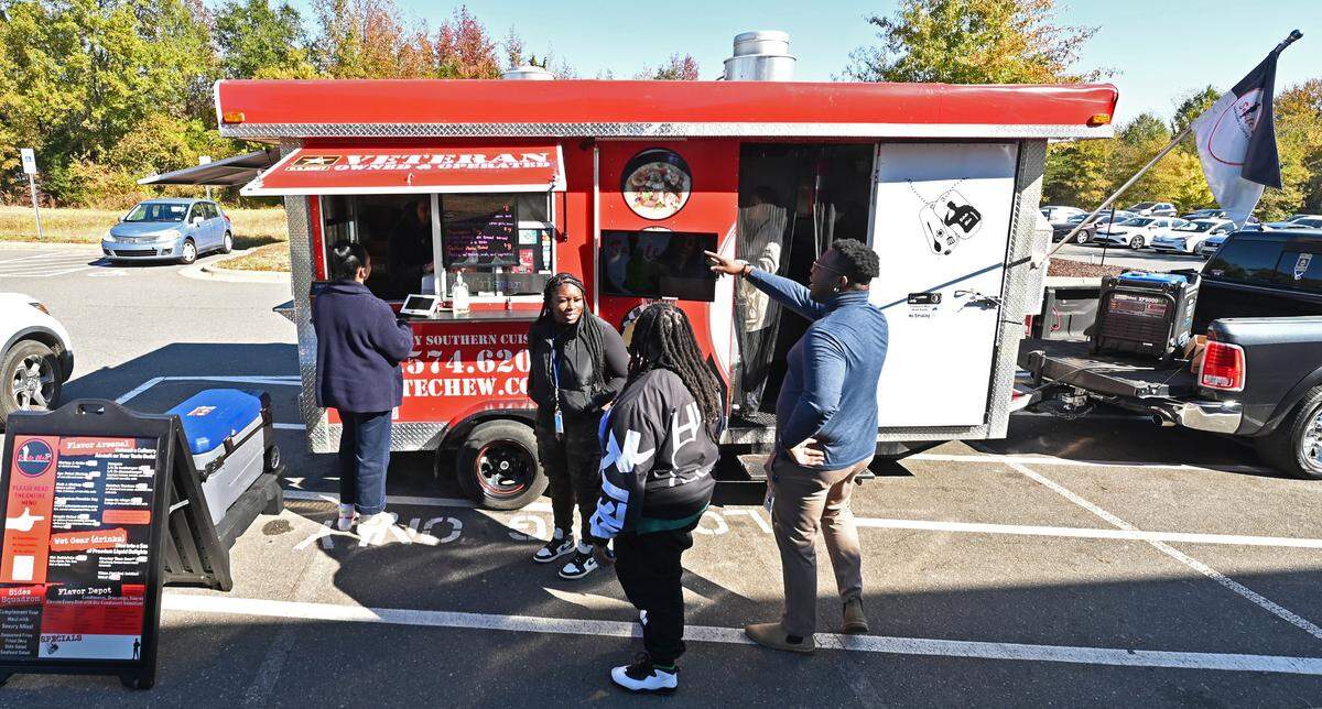 Office workers line up to purchase lunch from the Salute Chew food truck at Whitehall Corporate Center in Charlotte last week.