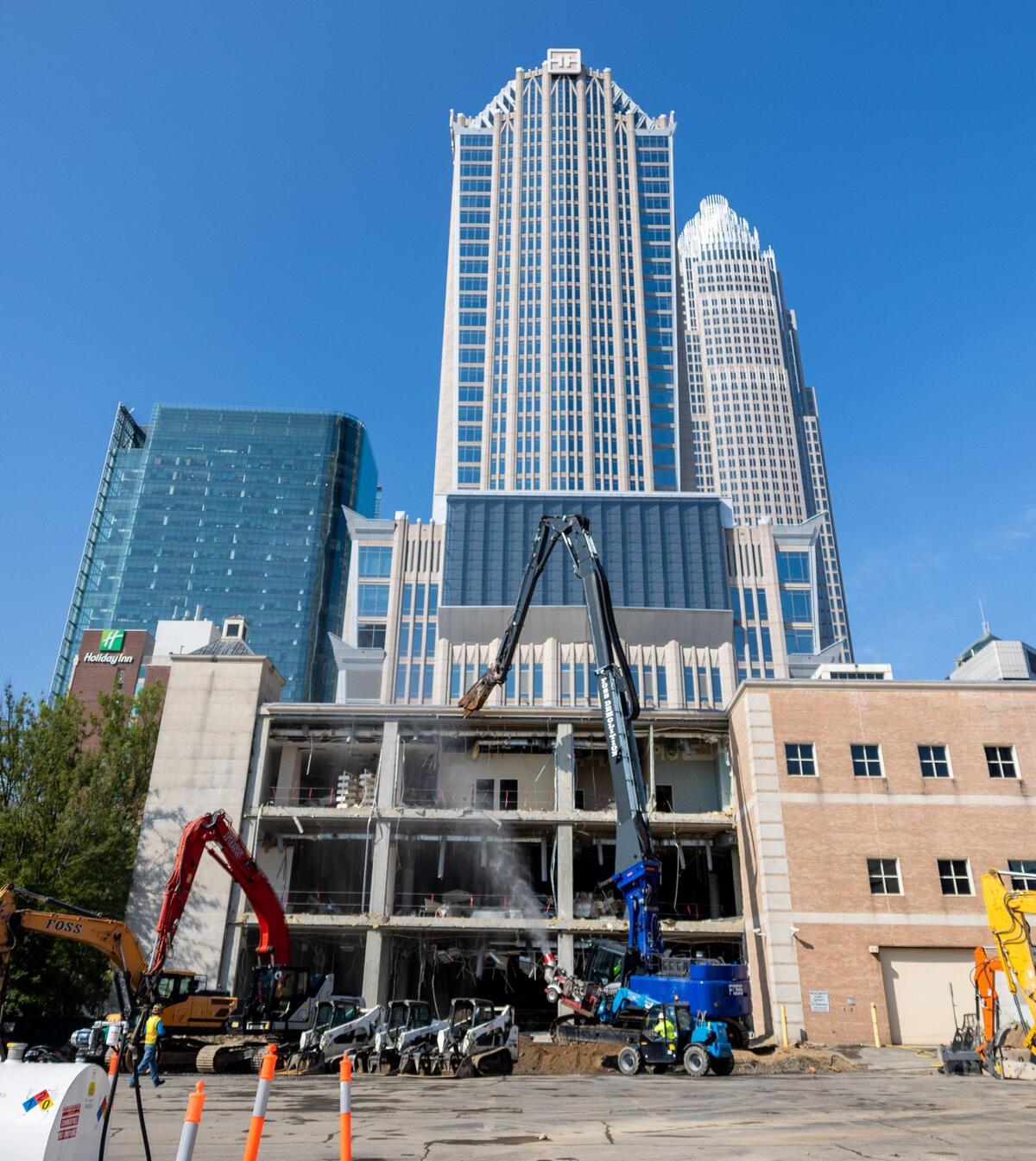 A Rodgers-Leeper construction crew demolishes a part of the Main Library location in Uptown Charlotte on Tuesday, August 15, 2023. The Library has been slated for demolition for years as they make way for a new, state of the art facility. The builders expect to have the old building demolished by the end of the year and they are planning on completing the new library by 2026.