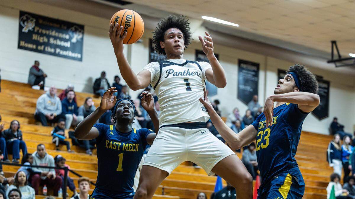 Providence Panthers Liam Drayton, center, grabs a rebound against the East Mecklenburg Eagles at Providence High School in Charlotte, N.C., on Thursday, February 5, 2026.

