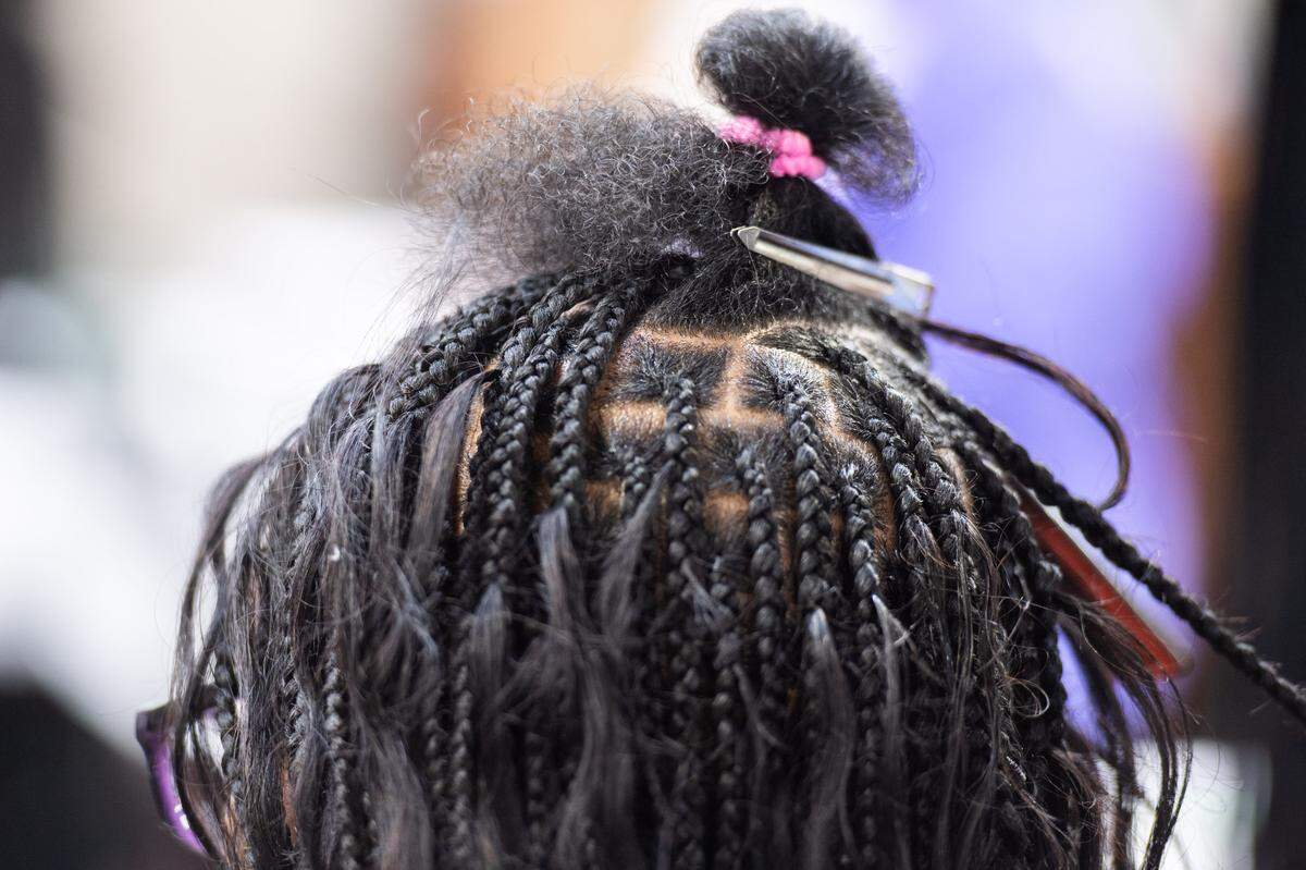 A woman getting knotless box braids at Top African Hair Braiding in Charlotte on August 7, 2024.