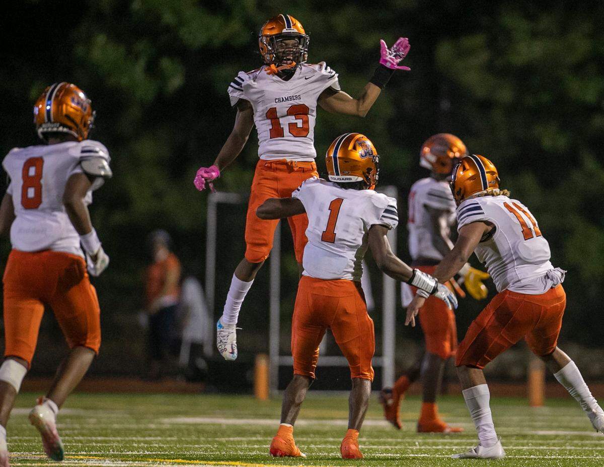 Julius Chambers’ players celebrate after an interception by Dante Harbison (11) late in the fourth quarter to seal their 35-29 victory over Cardinal Gibbons early Saturday morning August 21, 2021in Raleigh, N.C.