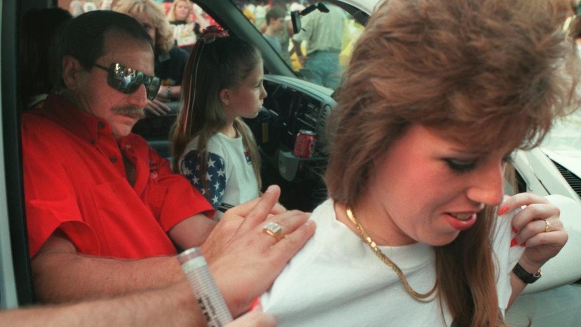 In May 1996, NASCAR star Dale Earnhardt signs a shirt being worn by Kary Kittredge before the 600 Festival parade in uptown Charlotte. Earnhardt was always willing to sign items for fans, including a UPS hat that he autographed the day he died. That hat now belongs to his son, Dale Earnhardt Jr.