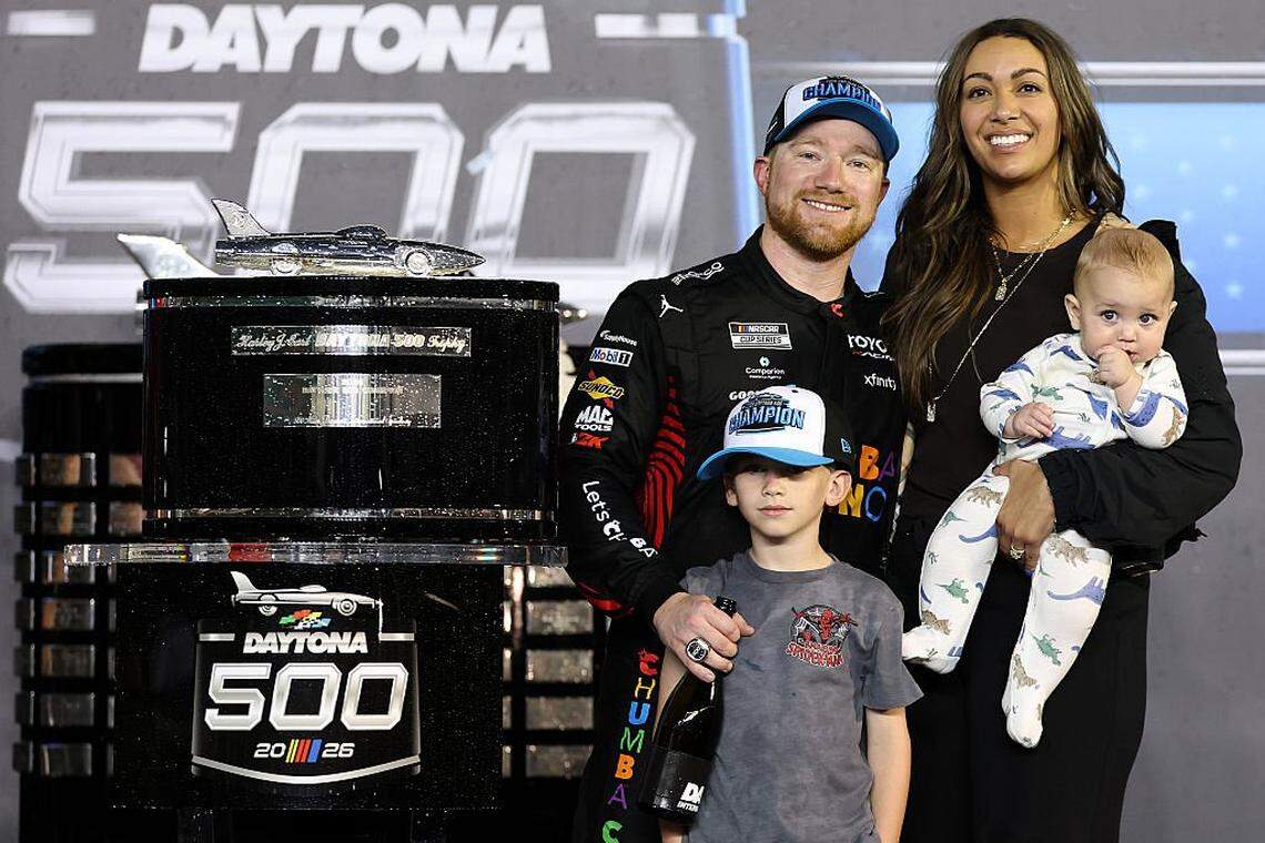 DAYTONA BEACH, FLORIDA - FEBRUARY 15: Tyler Reddick, driver of the #45 Chumba Casino Toyota, wife, Alexa De Leon and sons, Beau Reddick and Rookie George Reddick celebrate in victory lane after winning the NASCAR Cup Series Daytona 500 at Daytona International Speedway on February 15, 2026 in Daytona Beach, Florida. (Photo by Chris Graythen/Getty Images)