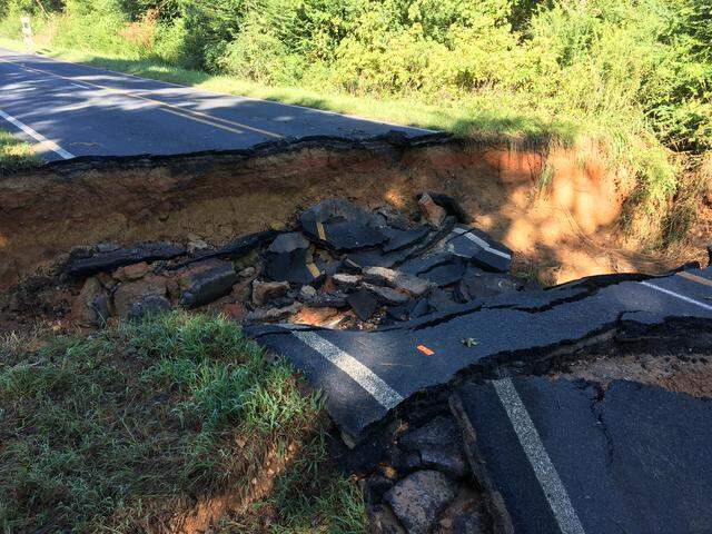 This section of Mayesville Road in southern Anson County, N.C. collapsed after water from an overflowing creek washed away dirt under the roadway.