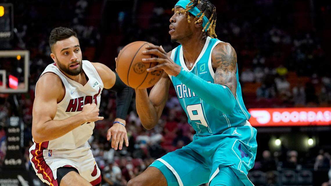 Miami Heat guard Max Strus, left, defends forward Wes Iwundu (9) during the second half of a preseason NBA basketball game, Monday, Oct. 11, 2021, in Miami. The Heat won 104-103. (AP Photo/Lynne Sladky)