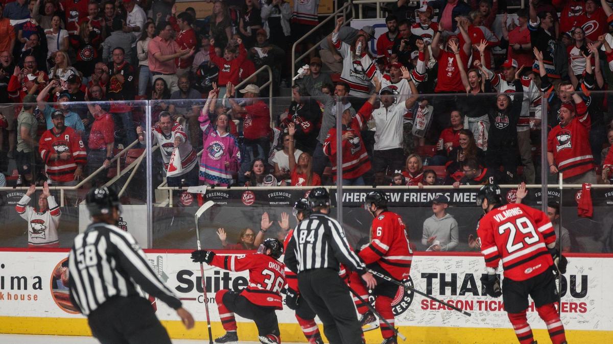 Fans cheer Checkers forward Oliver Okuliar celebrates scoring the first goal of the night during the Calder Cup opener against the Canucks at Bojangles Coliseum in Charlotte, NC on Friday, June 13, 2025.