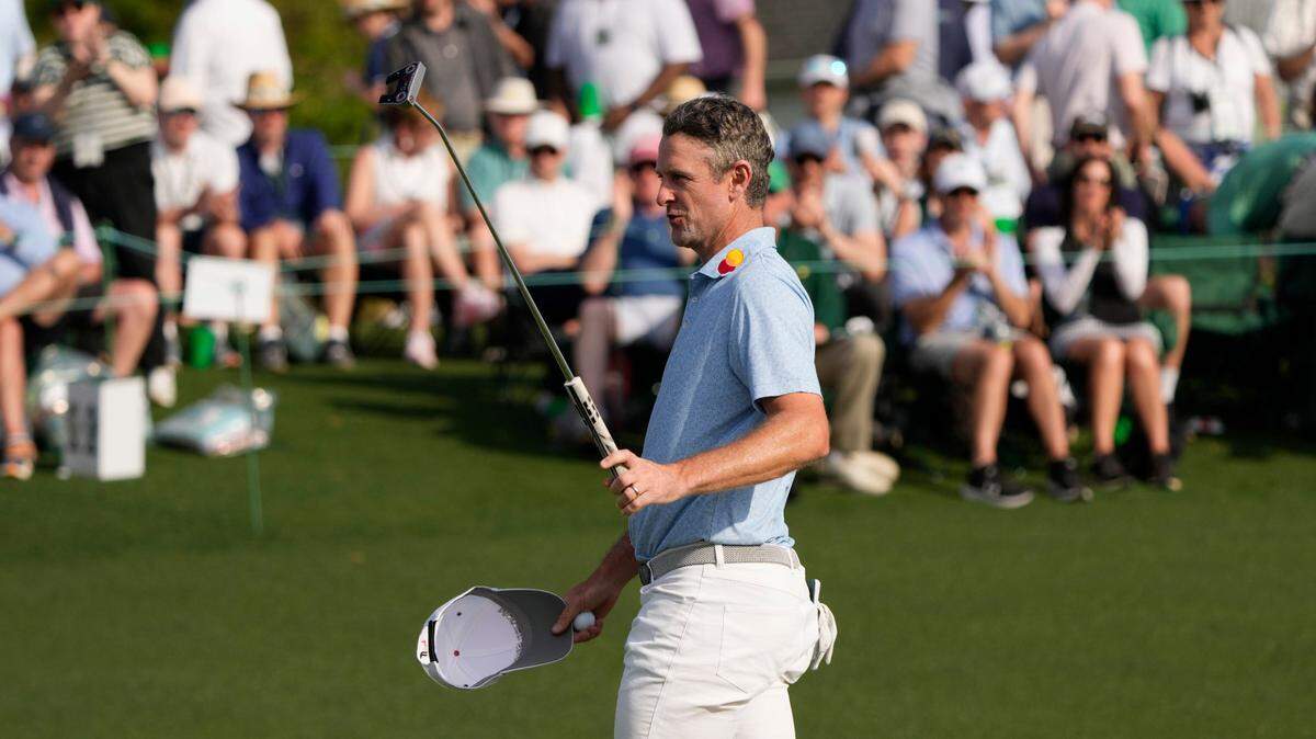 Justin Rose reacts on the 18th green during the first round of the Masters Tournament.