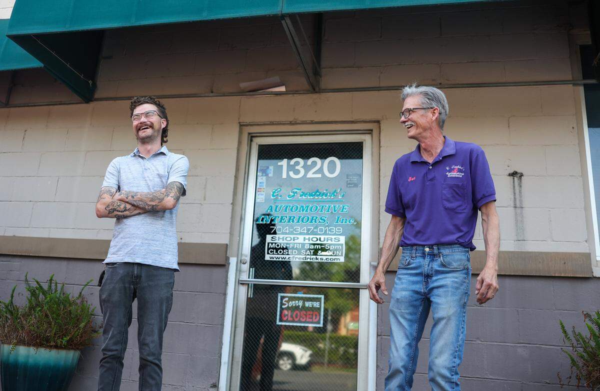 Trevor Floyd, left, and his dad, Fred Floyd pose for a portrait in front of C. Fredrick's Automotive Interiors Inc. In Charlotte, N.C., on Thursday, May 21, 2026.