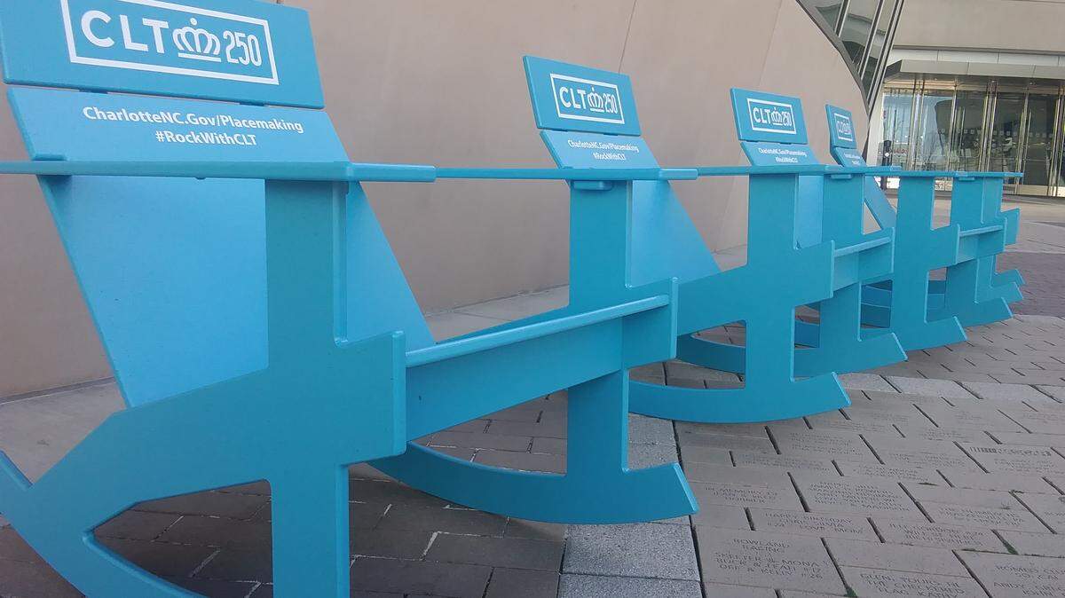 Bright blue rocking chairs began appearing in public places all around Charlotte on Wednesday, including these four at NASCAR Plaza in uptown. The chairs are part of the city’s celebration of its 250th birthday and will remain in place all year.