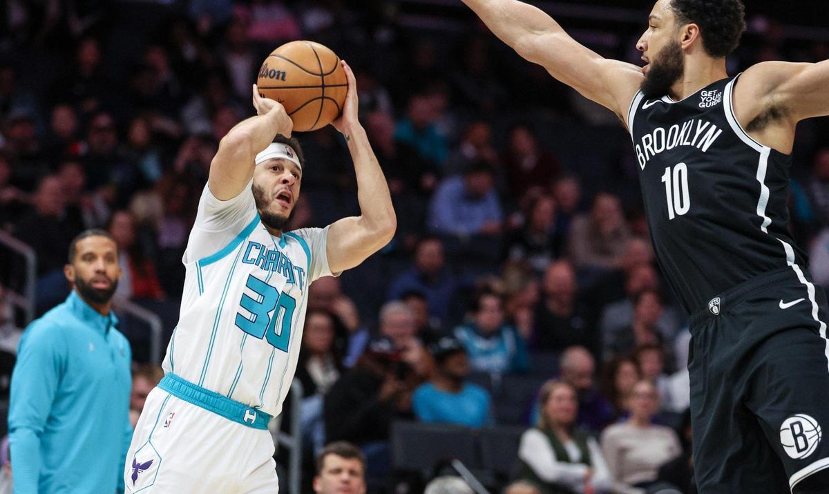 Hornets guard Serth Curry, left, takes aim for a shot as Nets forward Ben Simmons tries to block during the game at Spectrum Center in Charlotte, NC on Wednesday, January 29, 2025.