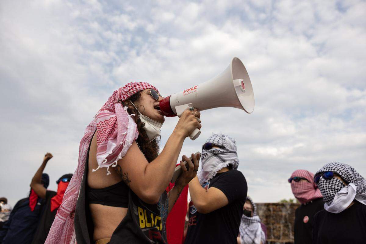 UNC Charlotte students and local activists march through campus during a rally for solidarity with Gaza and to protest student oppression at UNC Charlotte in Charlotte on Tuesday, May 7, 2024.