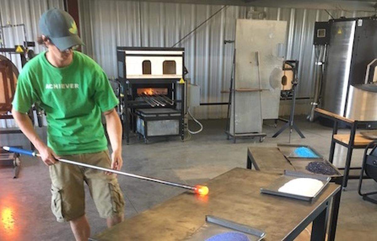 Jacob Pfeiffer blows glass at Hot Glass Alley.
