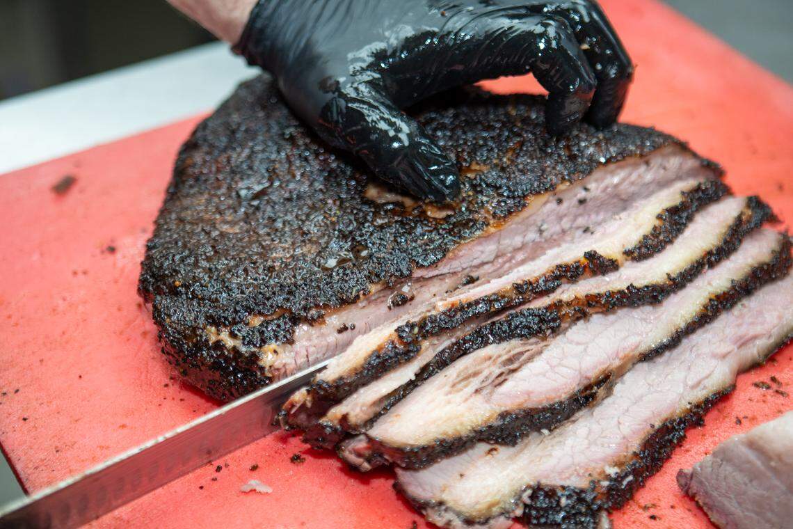 Slicing into a pork shoulder at The Smoke Pit in Concord.