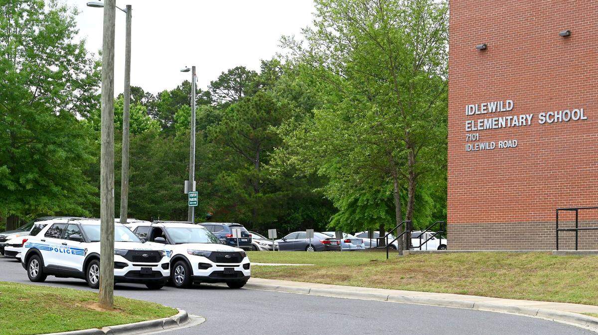 Two Charlotte-Mecklenburg Police cruisers sit outside Idlewild Elementary School on Wednesday, May 25, 2022. Following Tuesday’s shooting at a Texas school, Charlotte-Mecklenburg Police said it will increase patrols around elementary schools.