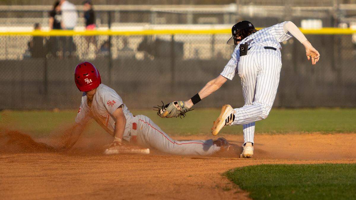 HoughÕs Colin Cusick is late to the tag as South MeckÕs Charles Fernandez slides safely into second base during a matchup against No. 1 South Meck and No. 3 Hough at Hough High School on Friday, March 24, 2023.