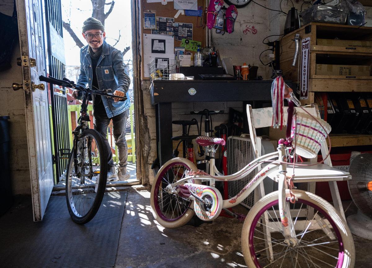 Eric Supil, executive director of Trips for Kids Charlotte, brings in two donated bikes to the shop in Charlotte.