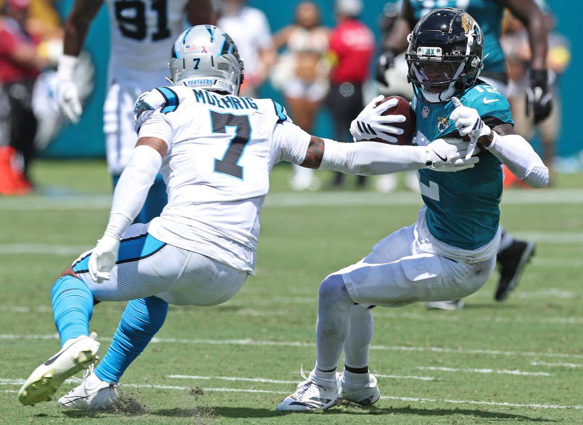 Carolina Panthers safety Tre'von Moehrig, left, attempts to make the tackle on Jacksonville Jaguars wide receiver Travis Hunter, right, during action on Sunday, September 7, 2025 at Everbank Stadium in Jacksonville, Florida.