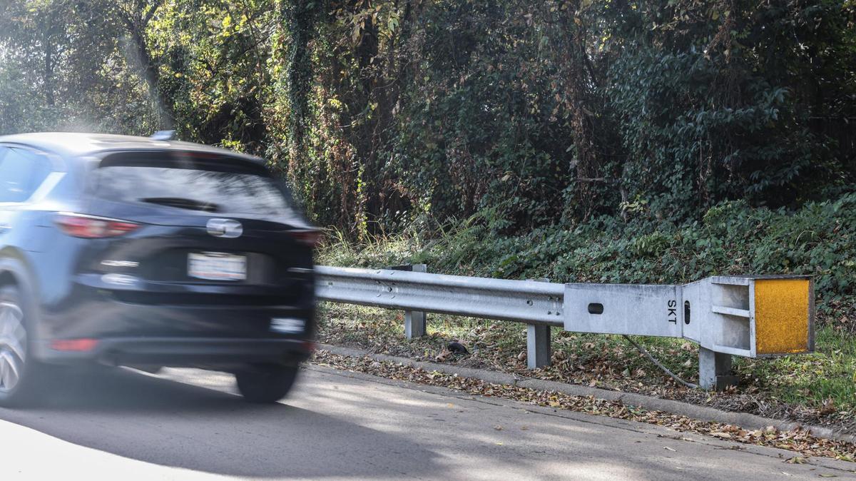 A car drives by a guardrail on the ramp to I-77 South from West Trade Street in Charlotte.