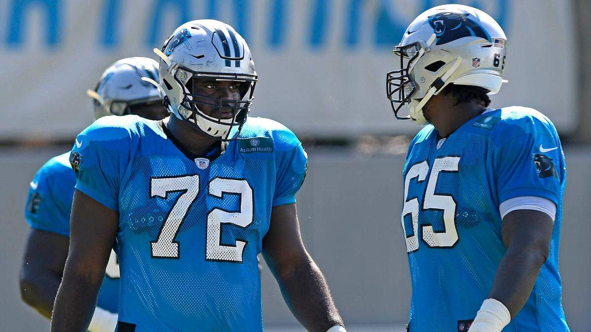 Carolina Panthers offensive tackle Taylor Moton (72) talks with offensive tackle Dennis Daley (65) at training camp in Charlotte in August. Moton is expected to have the franchise tag placed on him by the Panthers.