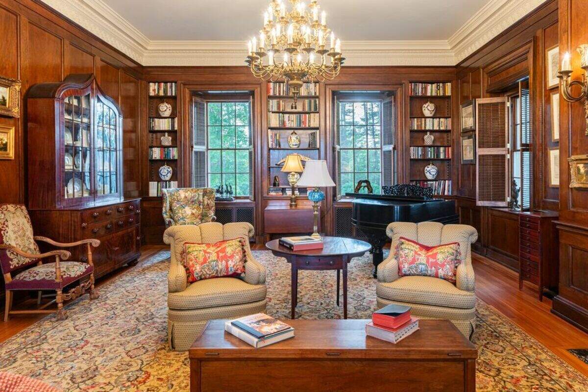Rooms of the mansion include large windows looking out to the forest.
