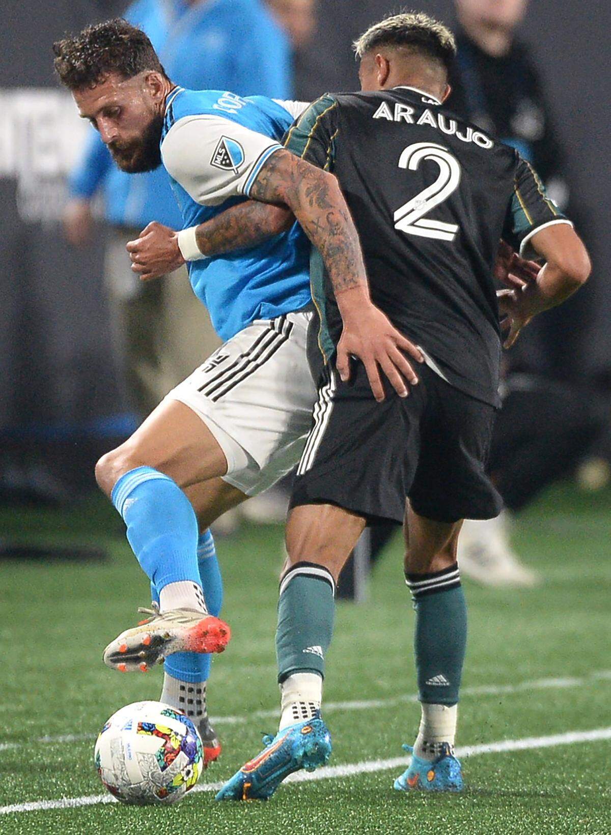 1Charlotte Football Club’s Guzman Corujo, left, fights to gain control of the ball against an LA Galaxy defender during first half action at Bank of America Stadium in Charlotte, NC on Saturday, March 5, 2022.