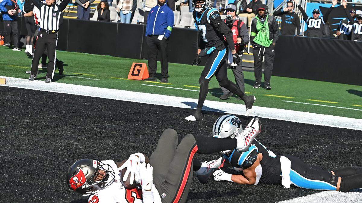 Tampa Bay Buccaneers cornerback Jamel Dean, left, recovers a fumble by Carolina Panthers wide receiver DJ Chark, center, in the end zone during second-quarter action at Bank of America Stadium in Charlotte, NC on Sunday, January 7, 2024.
