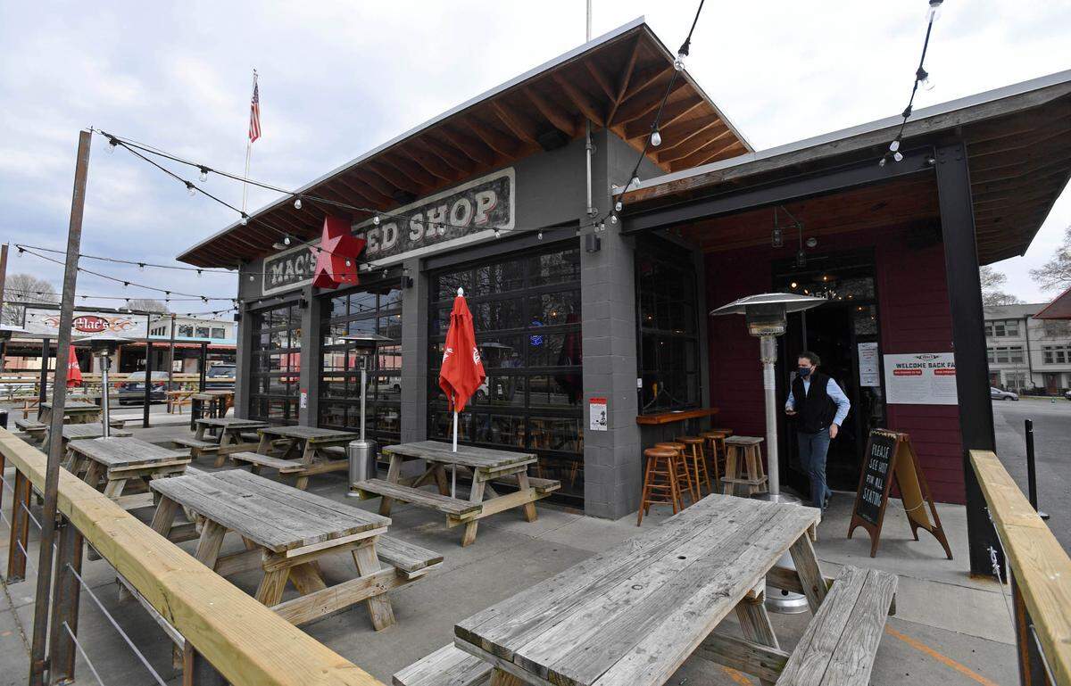 A customer exits MacÕs Speed Shop on South Boulevard on Monday, March 15, 2021