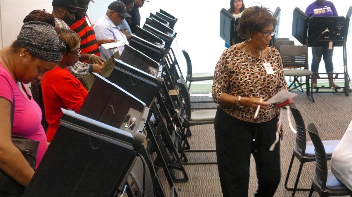 Voters inside a packed Beatties Ford Road Regional Library on the first day of early voting in Mecklenburg County.